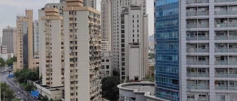 A high-rise building with multiple floors, surrounded by other tall buildings.