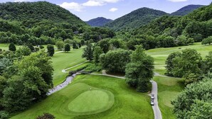 A golf course with multiple holes, a bridge, and a stream. - Newly Renovated Condo in Gated Golf Community (Whittier)