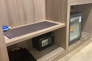 A room with a wooden desk, a black storage unit, and a glass cabinet with a sticker. - Accompanying Hotel·Yipin (Shanghai Lujiazui Financial and Trade Zone) (Shanghai)