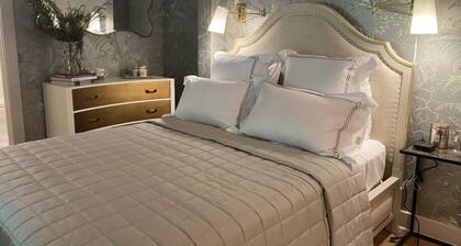 Elegant Carriage House room with a queen bed and private patio.