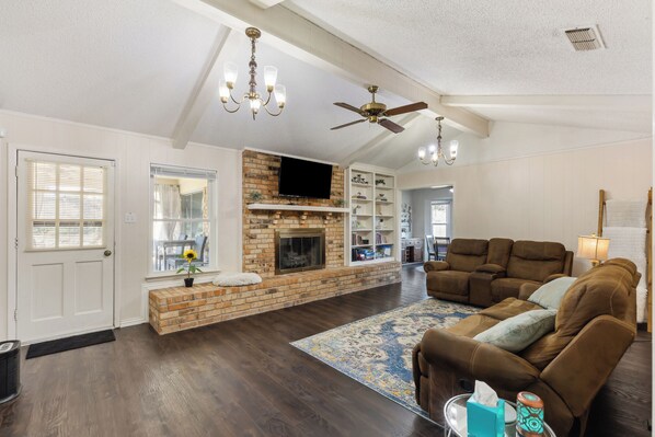 Smart TV, chimenea, libros, monitor de computadora