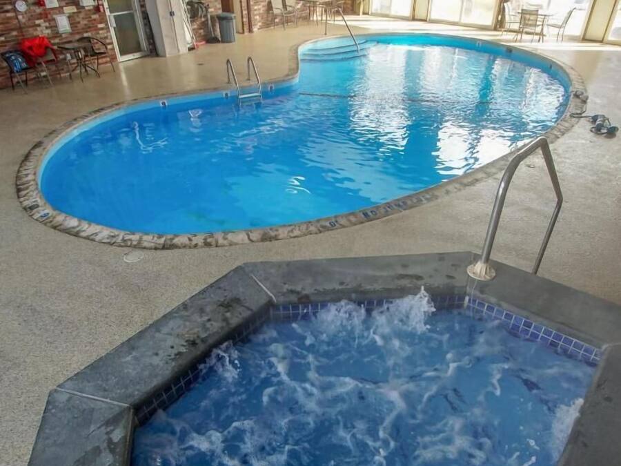 An indoor swimming pool with a hot tub area.
