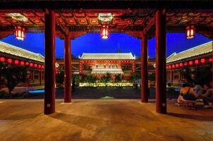 A traditional building with a tiled roof and red lanterns.