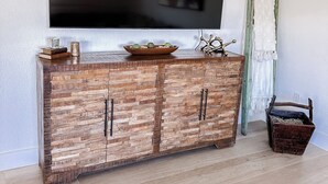 A wooden cabinet with a flat-screen TV mounted above it. - Welcome to Punta Paradise! Book Now! (Punta Gorda)