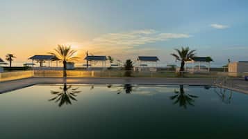 Outdoor pool, pool umbrellas, lifeguards on site