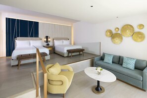 Una habitación de hotel moderna con dos camas, un sofá, una silla y una mesita de café.
