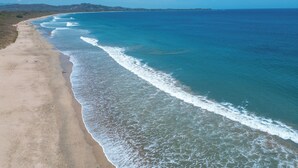 A beach with a long stretch of sand and gentle waves. - Beachfront AC Villa, 3BR, 3.5BA,  great surfing! Free Parking (Guanacaste Province)