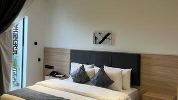 A modern bedroom with a wooden bed, a nightstand, and a ceiling light fixture.