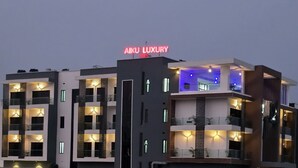 A multi-story building with a prominent 'AIKU LUXURY' sign. - AIKU LUXURY HOTEL & RESORTS  (Uyo)