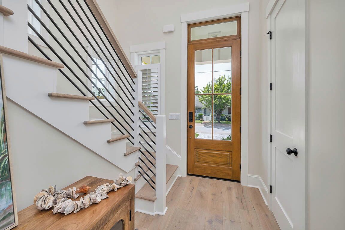 A staircase with wooden handrails and a wooden table with decorative items.
