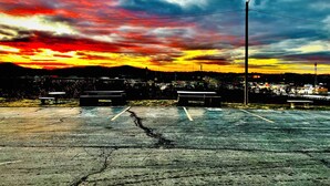 A parking lot with a sunset in the background. - Hometown INN (Berea)