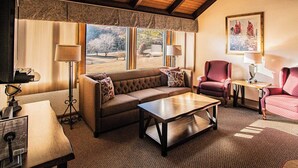 A cozy living room with a sofa, armchairs, a coffee table, and a fireplace. - Mountain Retreat w/ Pools & Fireplace (Lake Lure)