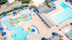 A pool area with multiple swimming sections, sun loungers, and umbrellas. - Mountain Retreat w/ Pools & Fireplace (Lake Lure)