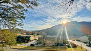A residential area with houses, a clear sky, and a mountain in the background. - Mountain Getaway | Pools, Trails & More! (Lake Lure)
