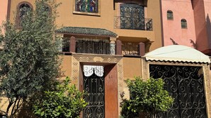 A multi-story building with a traditional architectural style, featuring ornate iron gates and decorative window frames. - 2-bedroom villa in fabulous Marrakech with WiFi, AC (Marrakech)