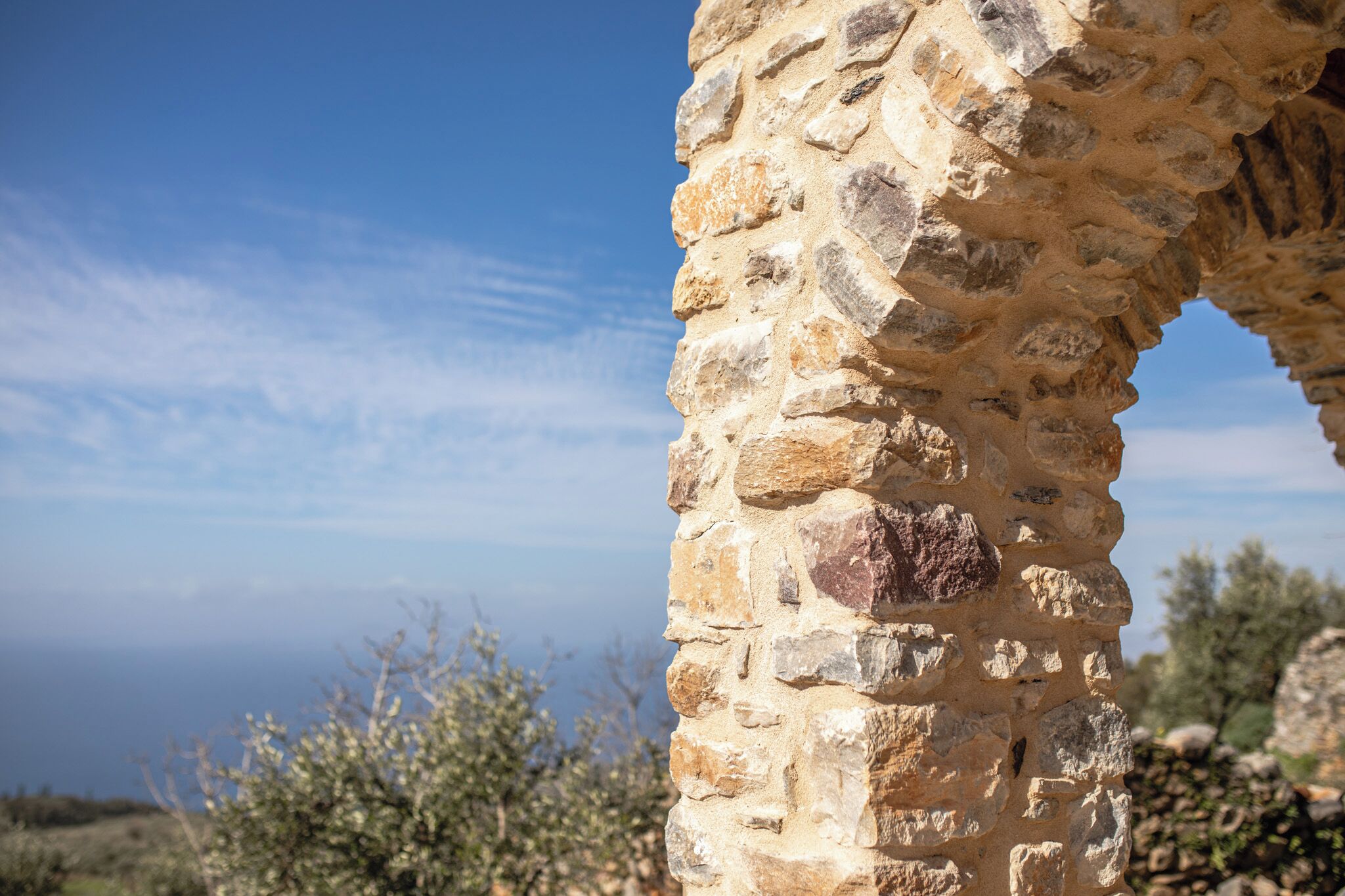 A stone structure with a clear view of the sea and sky.