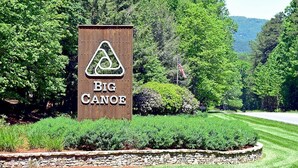 A wooden sign with the text "BIG CANOE" and a triangular logo. - Scenic Getaway in Jasper Mountains (Marble Hill)