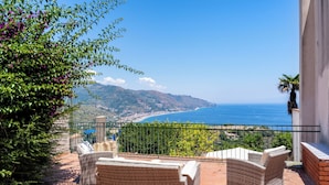 A patio with wicker furniture overlooking a coastal view. - Villa Valmar - Villa with a view (Taormina)