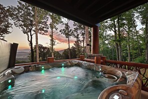 A hot tub with a view of a forest and mountains. - Misty Mountain Luxury mountain cabin with breathtaking views, hot tub, & game room! (Murphy)