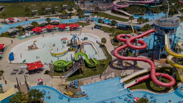 An aerial view of a water park with multiple slides and pools. - Family Getaway with Huge Private Yard • 5 min to Beach • Peaceful Are (Gulfport)