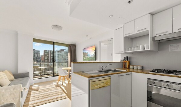 A clean and tidy U-shaped kitchen featuring white cabinetry