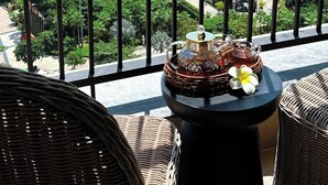 A balcony with a view of the sea, a bridge, and buildings. - Azure Premium Apartments (Phu Quoc)