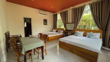 Family Room, Garden View | Desk, laptop workspace, blackout drapes, WiFi (free)