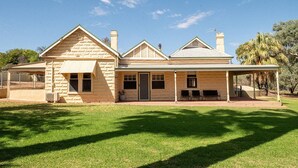 A stone house with a covered porch and a fenced yard. - The River Block (Bookpurnong)