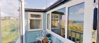 Sandford is a charming, traditional beach chalet, with great sea views.