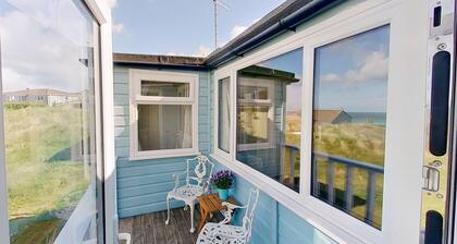 Sandford is a charming, traditional beach chalet, with great sea views.