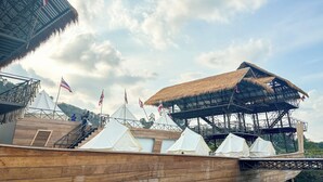A wooden deck with white tents and a thatched-roof structure. - Thailand Mountain Phuket (Patong)