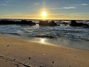 Enjoy a serene beach experience with gentle waves lapping against the shore.