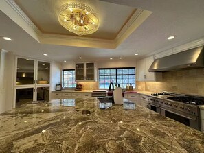 Enjoy cooking in this well-equipped kitchen with a gas stove, ample counter space, and modern cabinetry.
