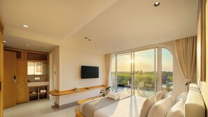 A modern hotel room with a large bed, a TV mounted on the wall, and a balcony with a view of the landscape. - Panorama Paddy Retreat - Luxury Villa & Pool (Thành phố Hội An)