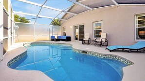An indoor swimming pool with a glass ceiling, lounge chairs, and a seating area. - Fully Renovated Disney Villa with Private Pool, King size Beds in Davenport (Davenport)