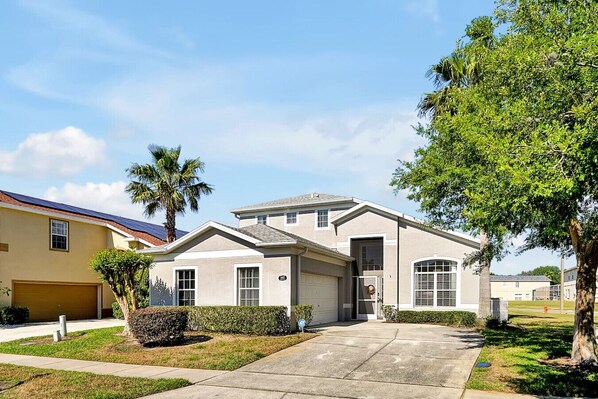 A single-story house with a garage, a front door, and a driveway.