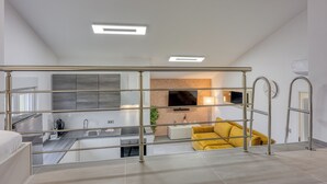 A modern apartment with a kitchen, living area, and balcony. - Royal Premantura (Medulin)