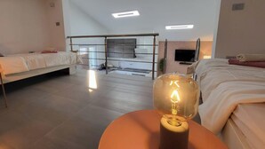 A modern hotel room with a bed, a desk, and a large window. - Royal Premantura (Medulin)