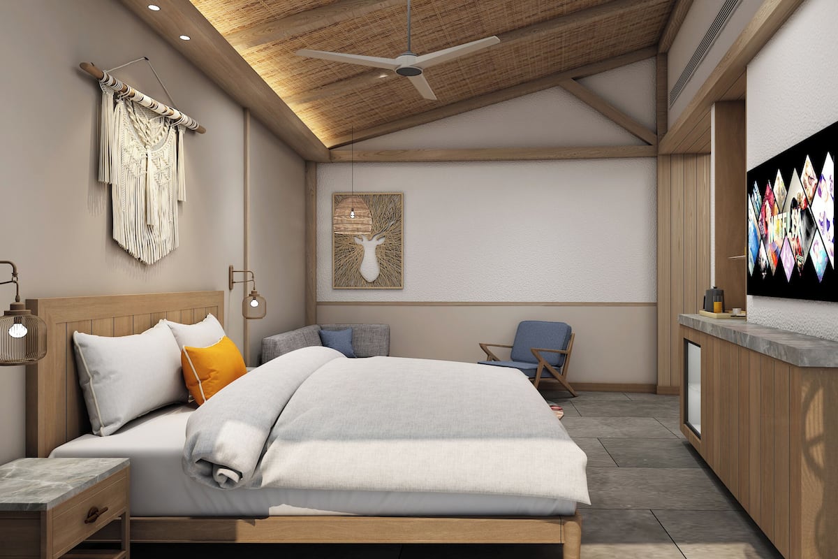 Ein modernes Schlafzimmer mit Bett, Nachttisch, Wandlampe, Deckenventilator und einem an der Wand befestigten Fernseher.