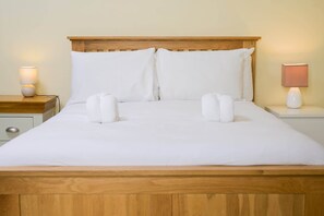 Restful retreat with a neatly made bed and bedside tables, each with a lamp for added ambiance.
