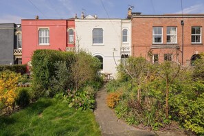 Stroll through a charming residential area surrounded by lush gardens and diverse architectural styles.