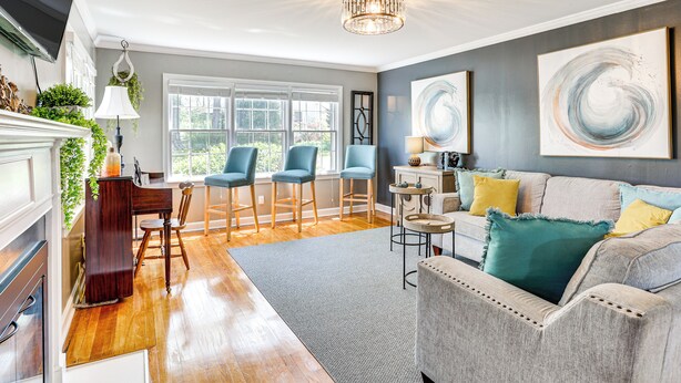 A living room with a fireplace, a dining area, and a sofa with cushions. - 12 Mi to BlueOval City: Tennessee Getaway! (Mason)