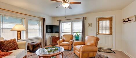 Relax in this inviting living room with a sofa, armchairs, and coffee table.
