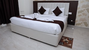 Una habitación de hotel moderna con una cama grande, un cabecero y una decoración en la pared.