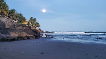 Private beach nearby, black sand