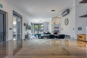 Enjoy a clean and minimalist space with a dining area, seating area, and comfortable furnishings.