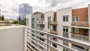 A modern apartment building with multiple floors, balconies, and a mix of residential units. - Mid-rise Modern Lux loft In The City (Sacramento)