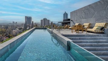 Relax by the rooftop pool with a stunning city view.