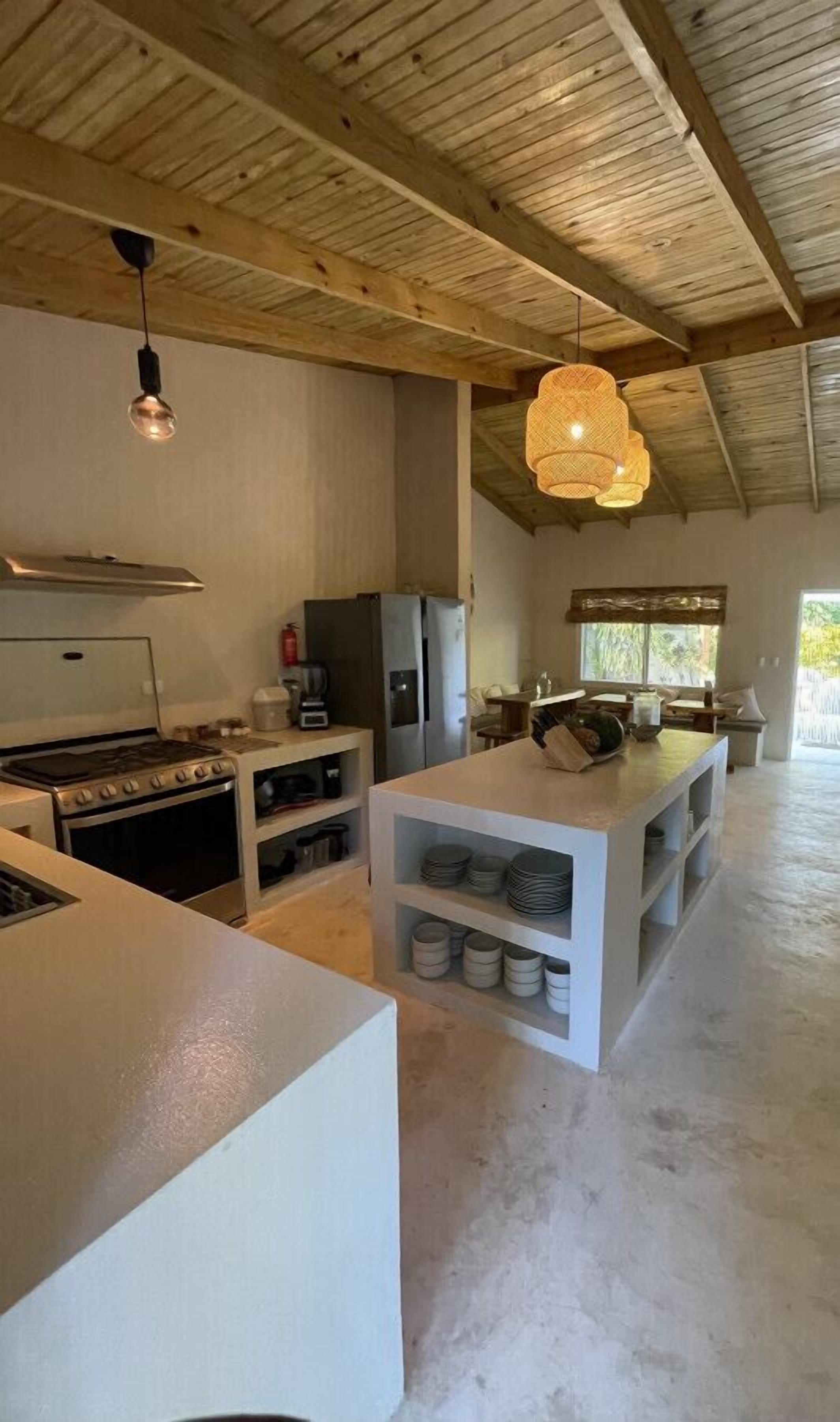 Coffee/tea maker, fridge, highchair, dining table