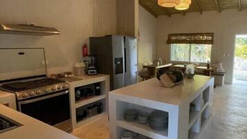 Coffee/tea maker, fridge, highchair, dining table